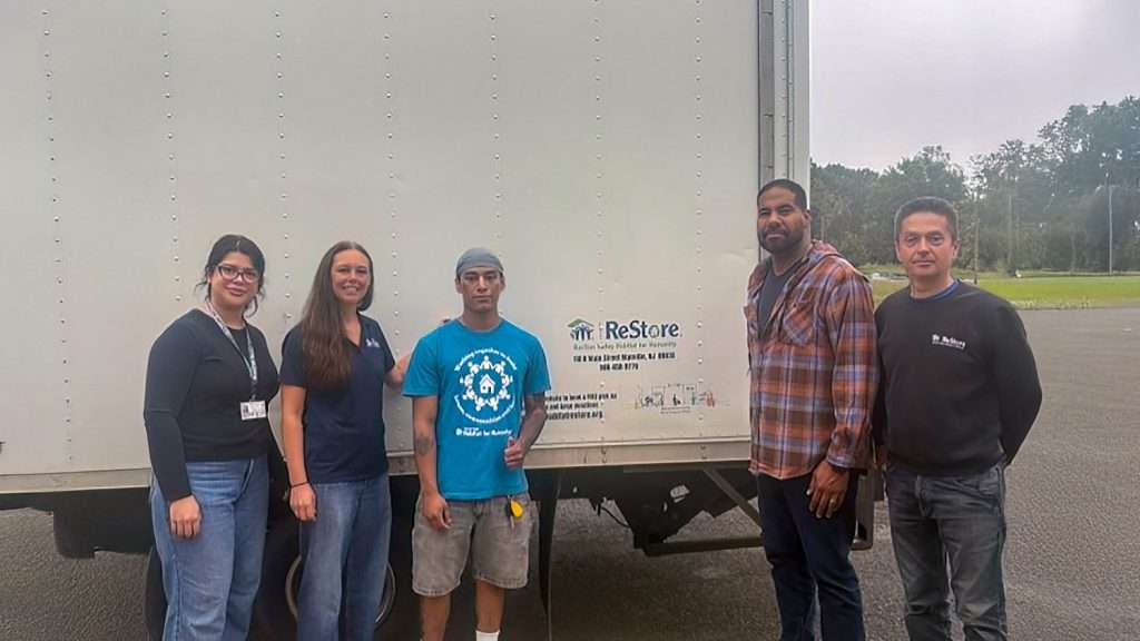 Image of staff standing by ReStore truck